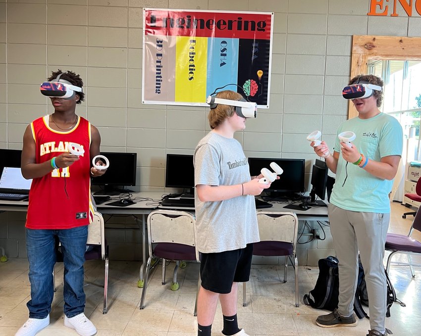 Jae’len Clemons, Hayden Yandell and Bailey Dumas use VR technology in class.